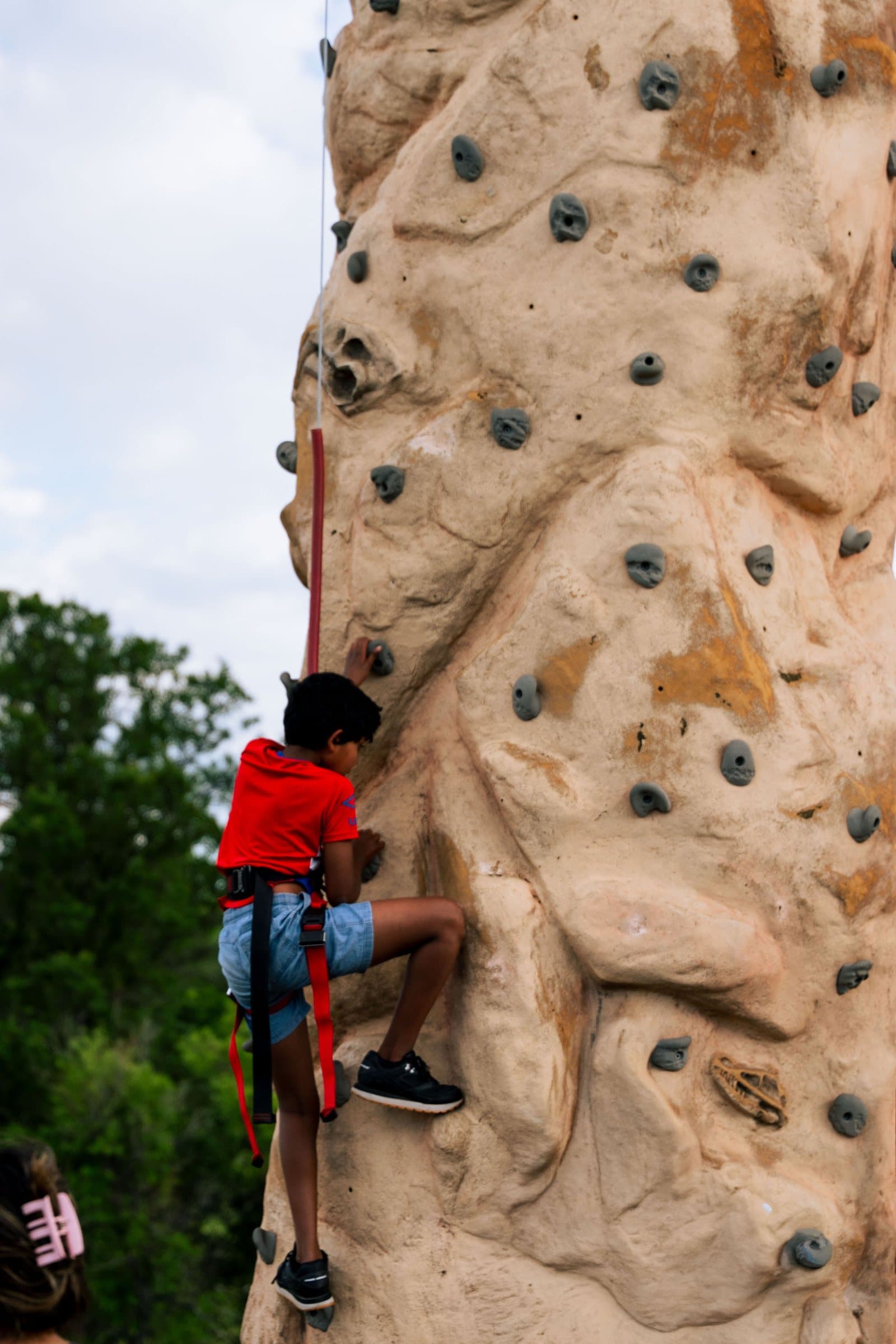 Child climbing the rock wall at Castle Pines Food Truck Frenzy