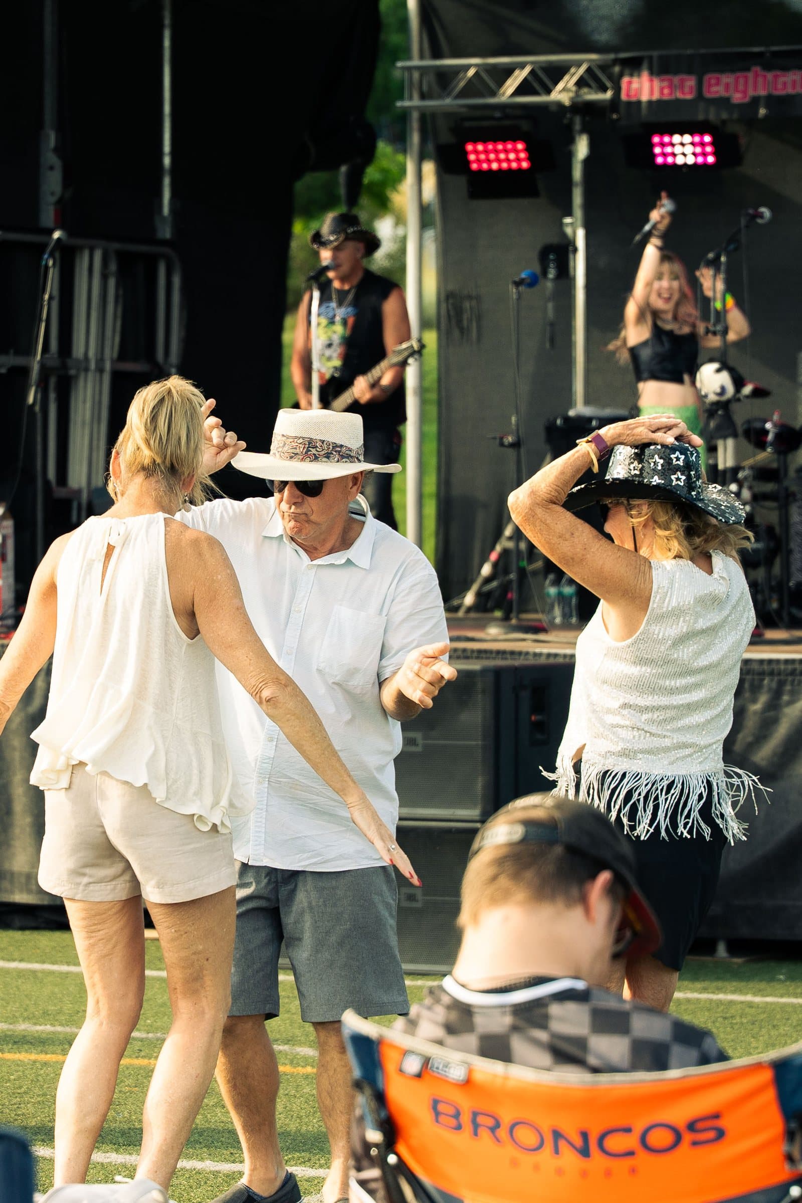 Couple dancing in front of the stage at the Castle Pines 80s concert