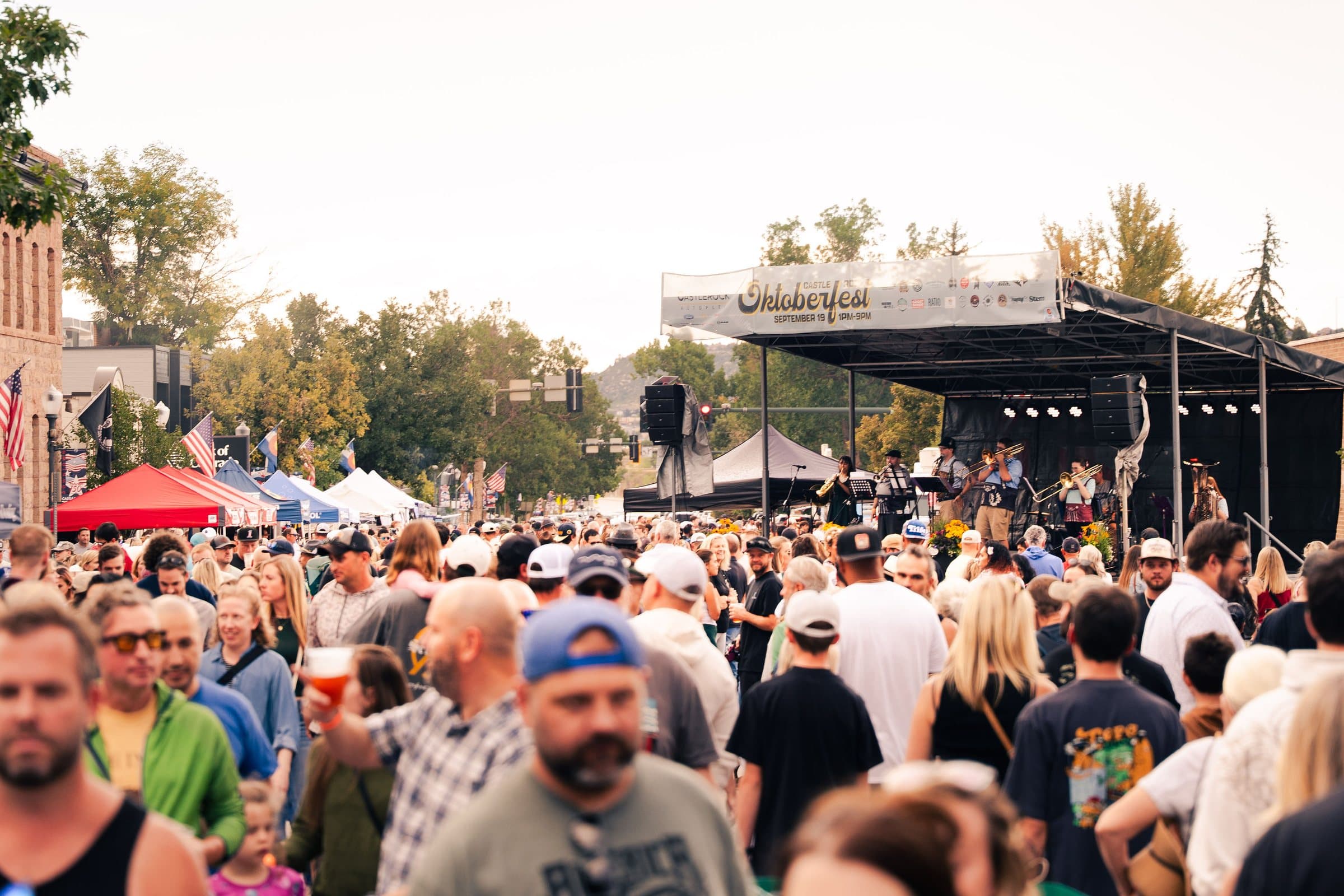 Crowd filling downtown Castle Rock at Oktoberfest 2026, Colorado event photography