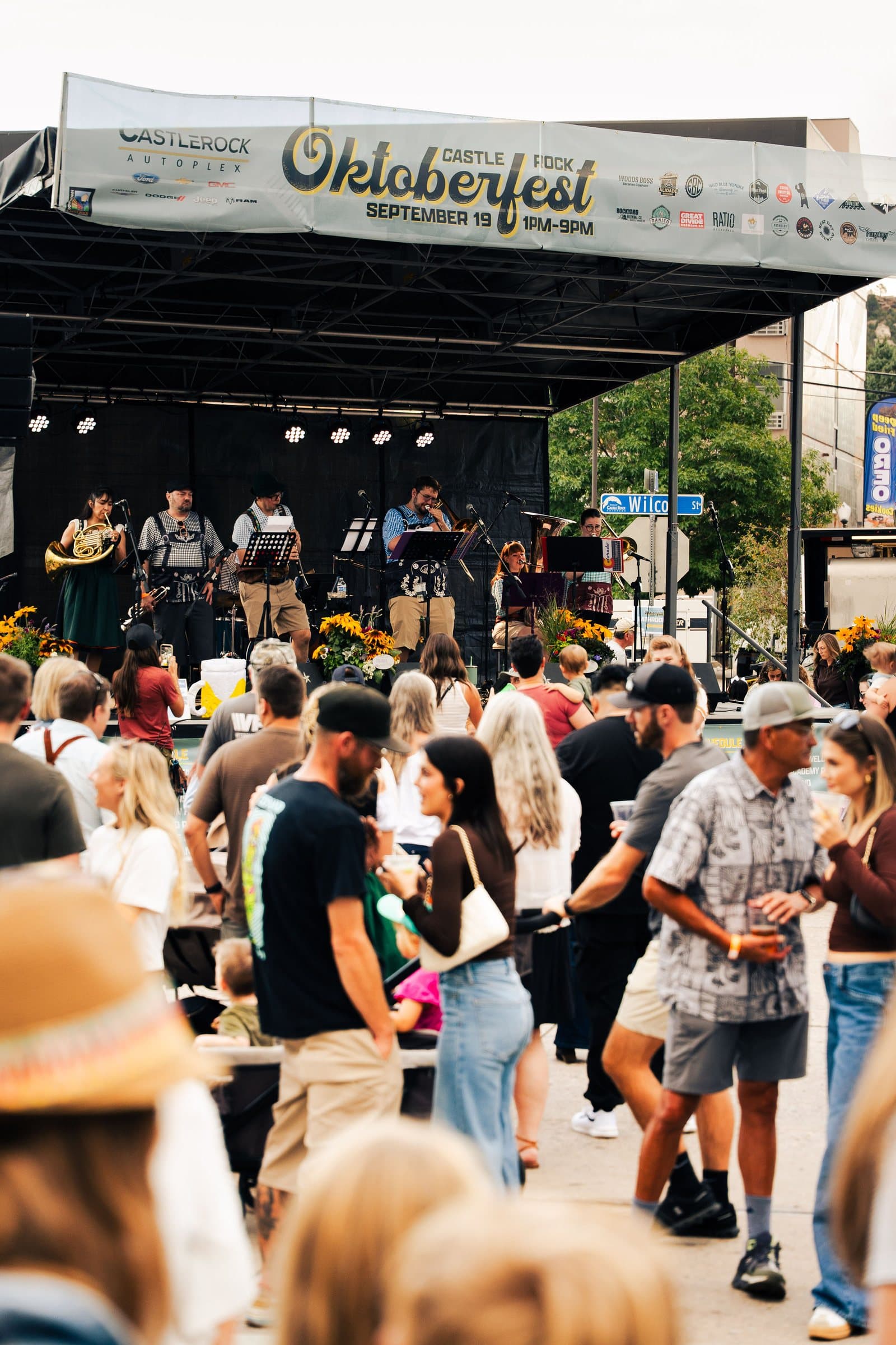 Festival-goers gathered in front of the Oktoberfest stage in downtown Castle Rock, Colorado