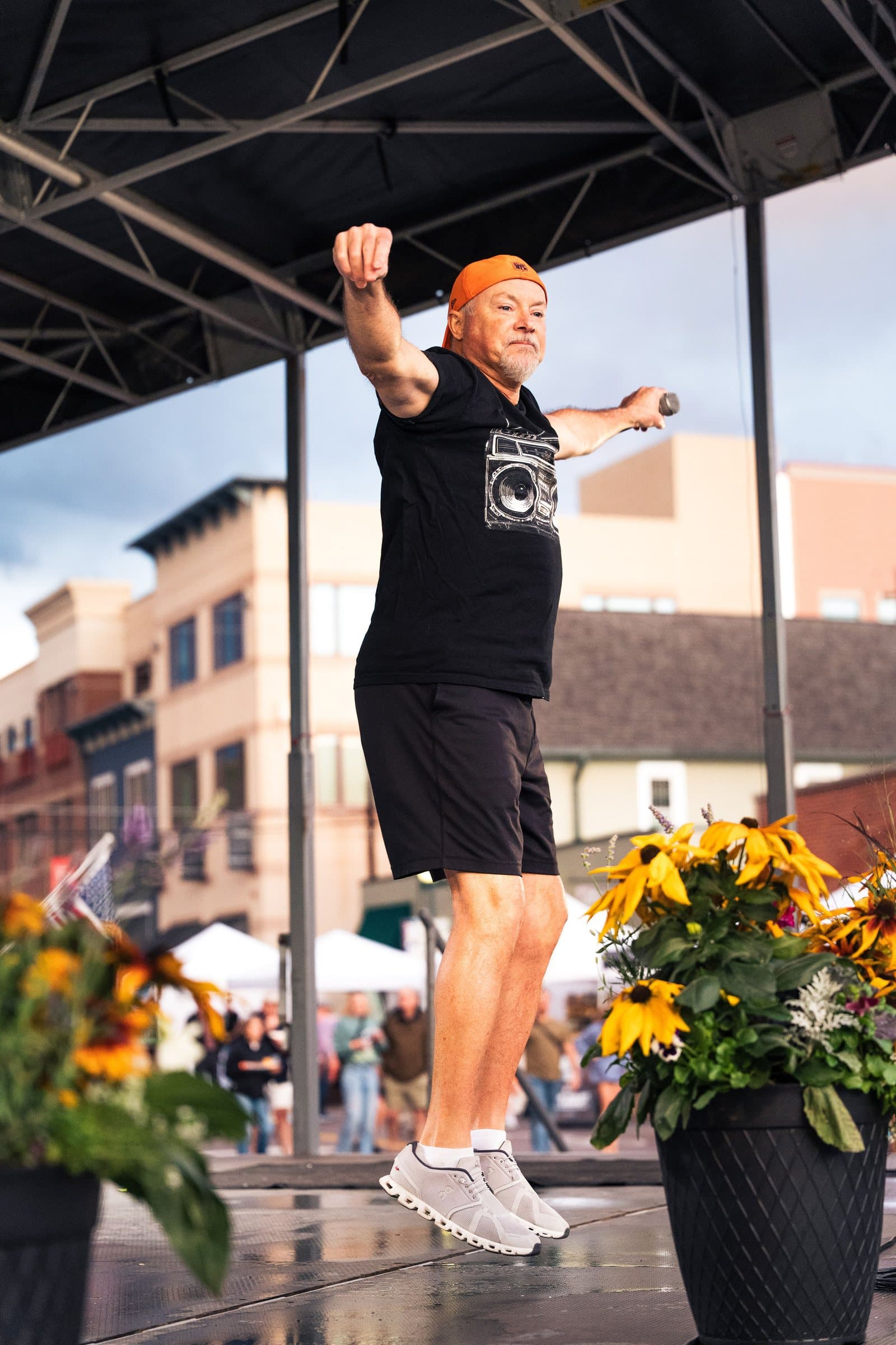Emcee jumping on stage to hype the crowd at Castle Rock Oktoberfest