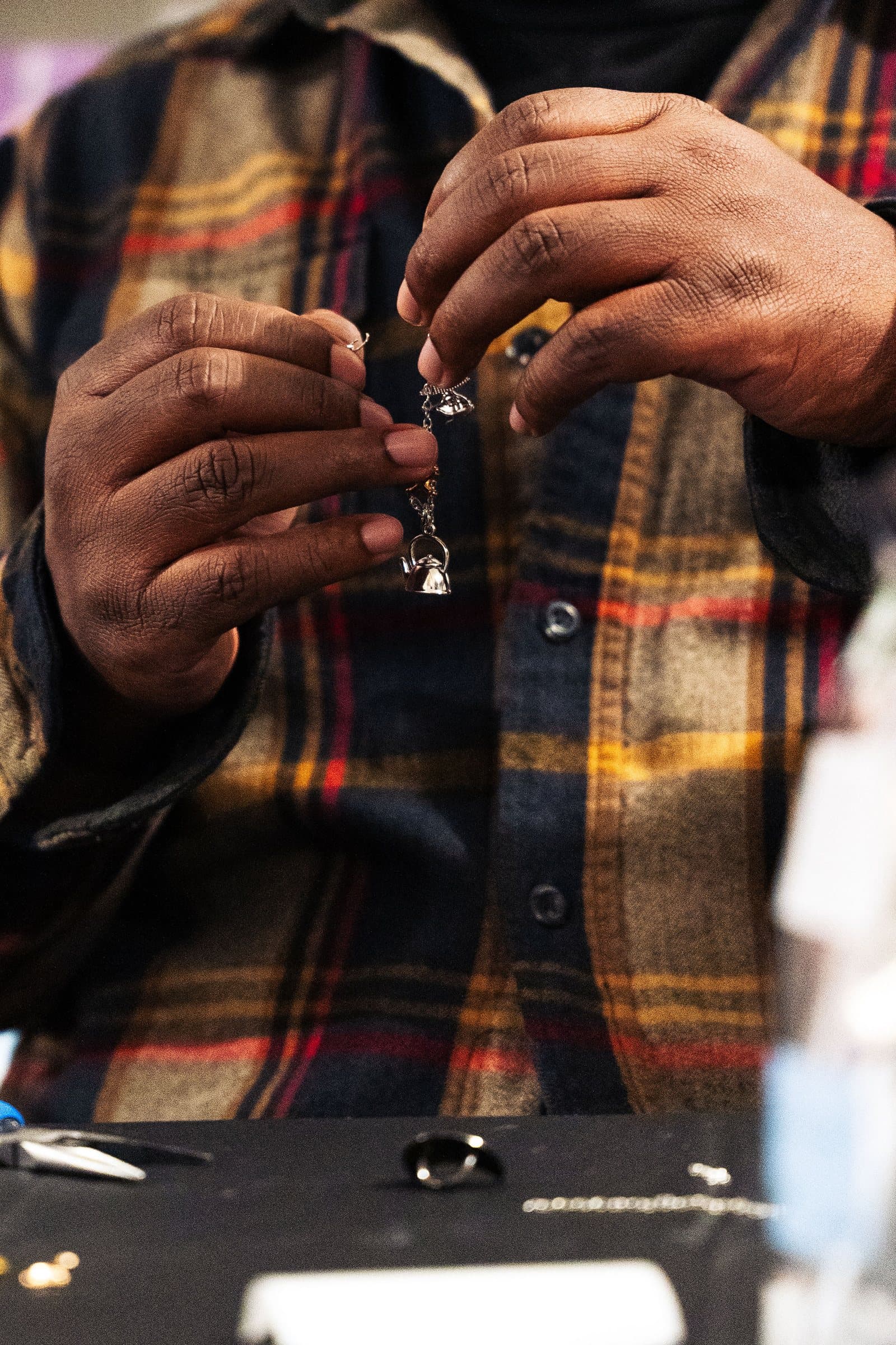 Maker's hands crafting jewelry at Corner Nook, Colorado brand photography
