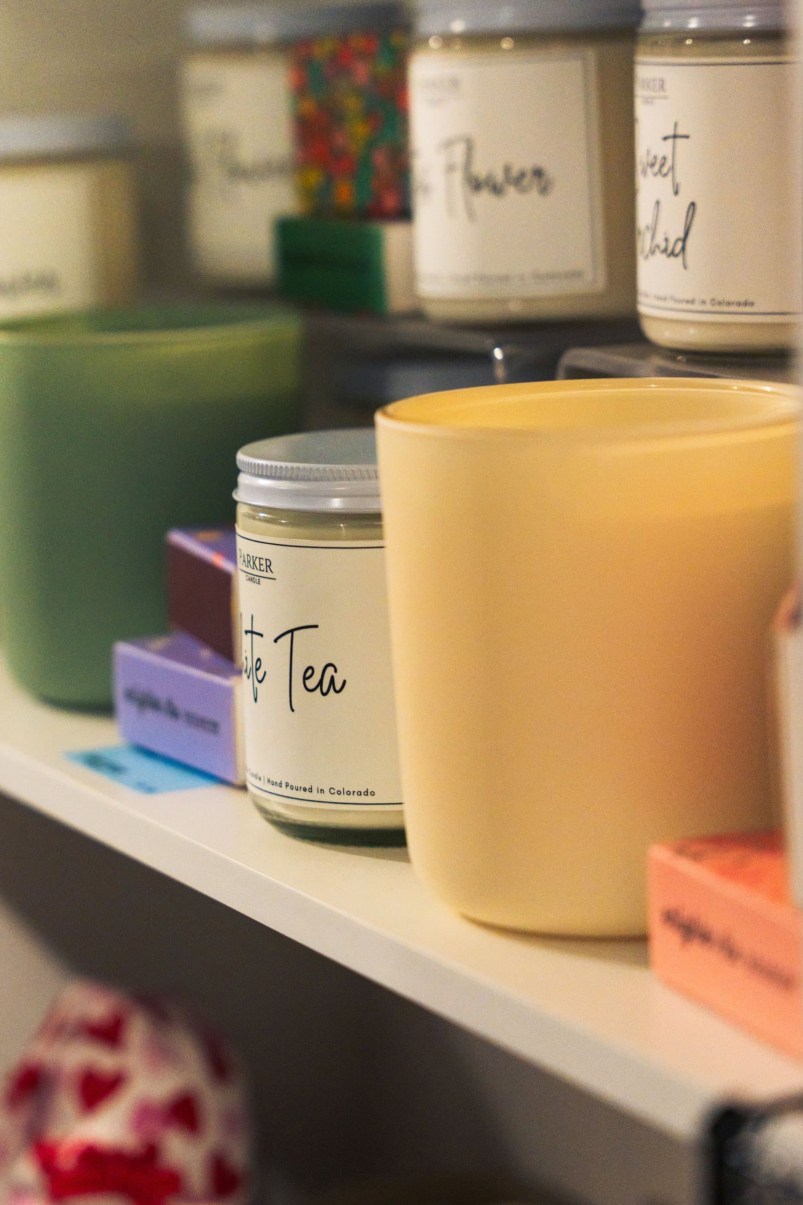 Handmade candles on a shelf at Corner Nook boutique