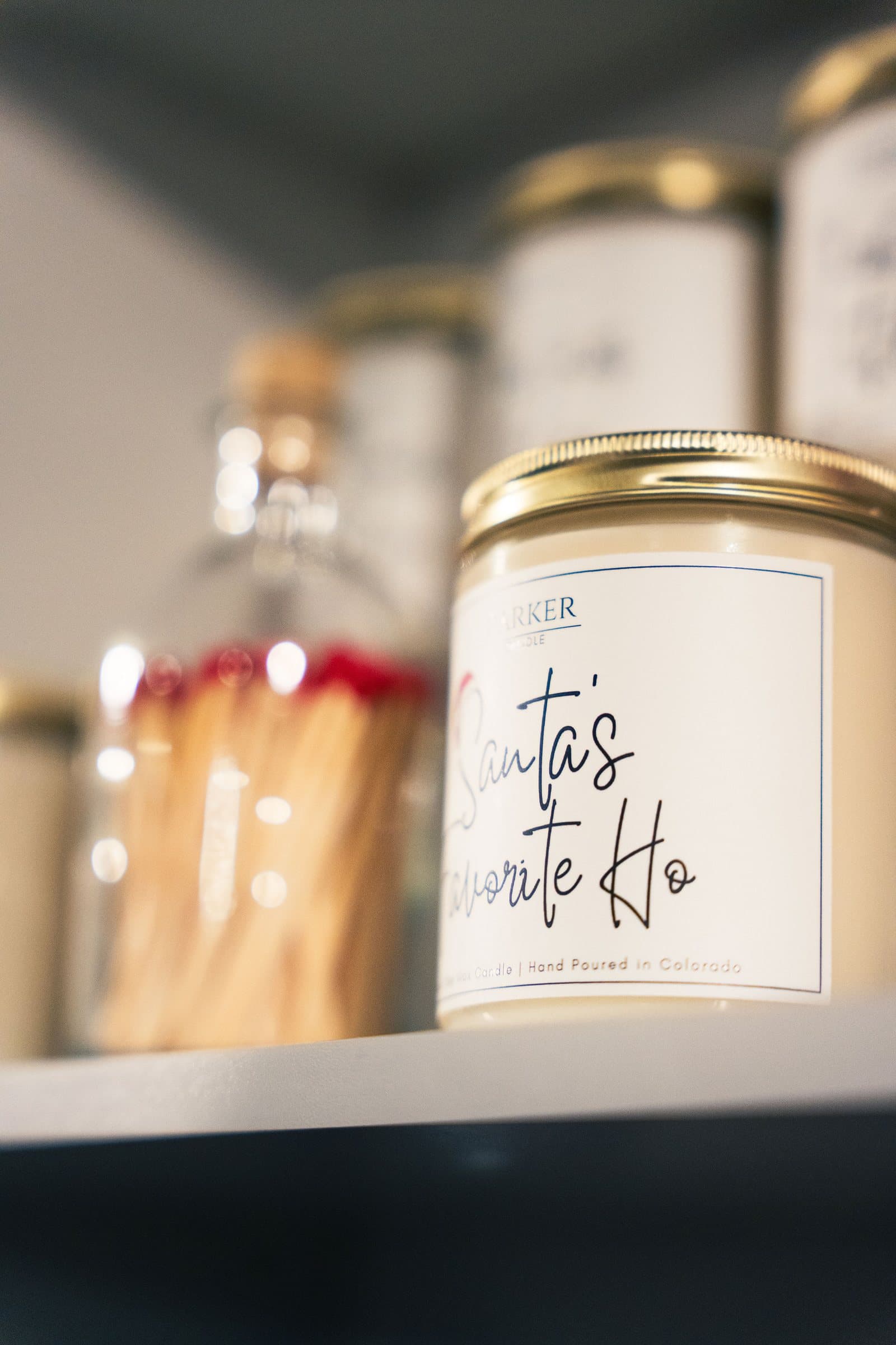 Soy candle and match jar styled on a boutique shelf