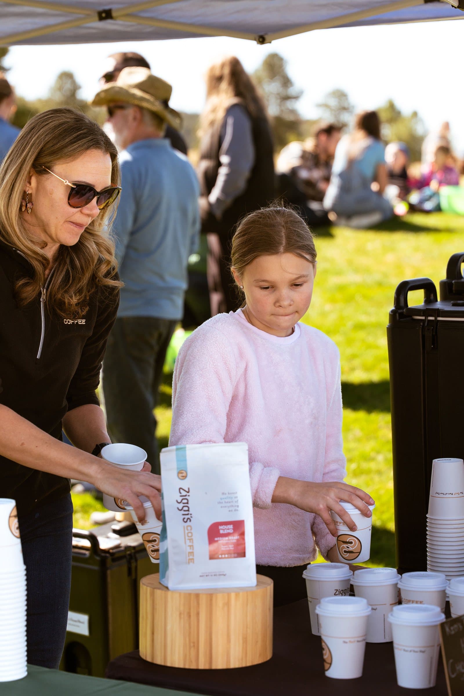 Volunteer handing out treats to a child at the Easter event