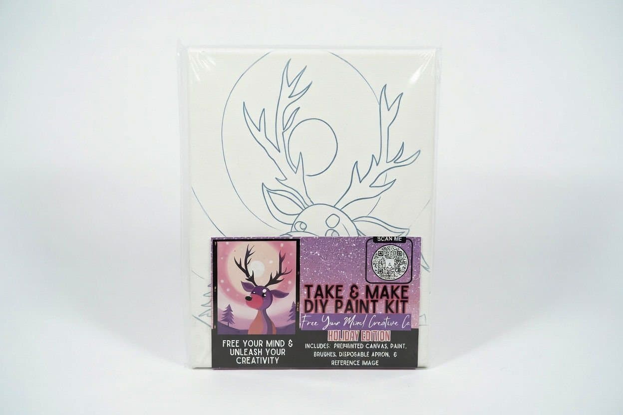 Take-and-make paint kit with pre-drawn canvas on a white backdrop