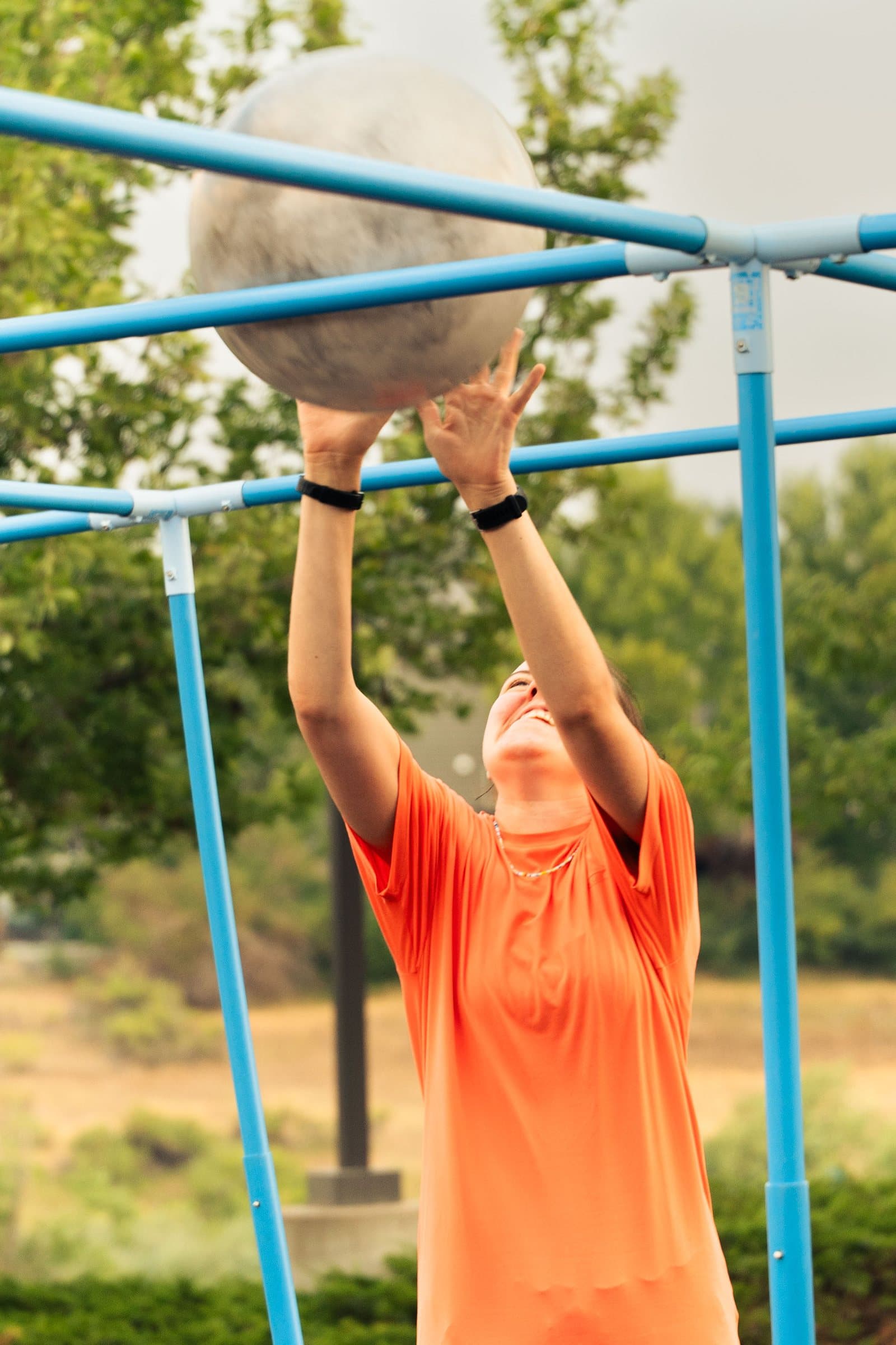 Student reaching for a giant ball during a church youth group game