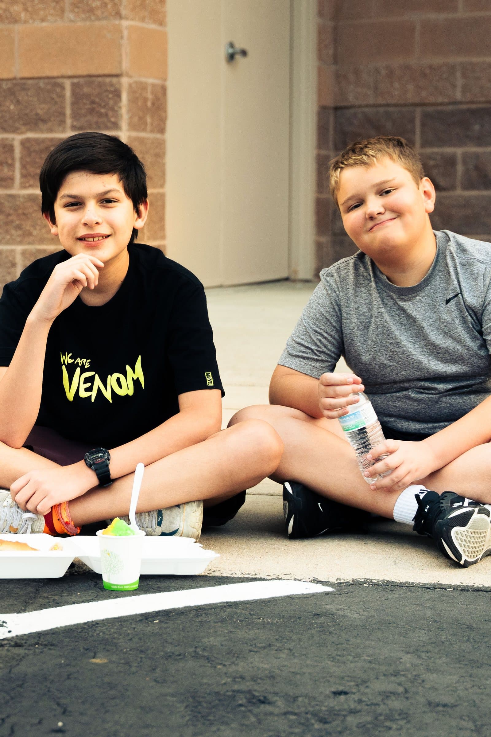 Two teens sitting and laughing together at a church youth event