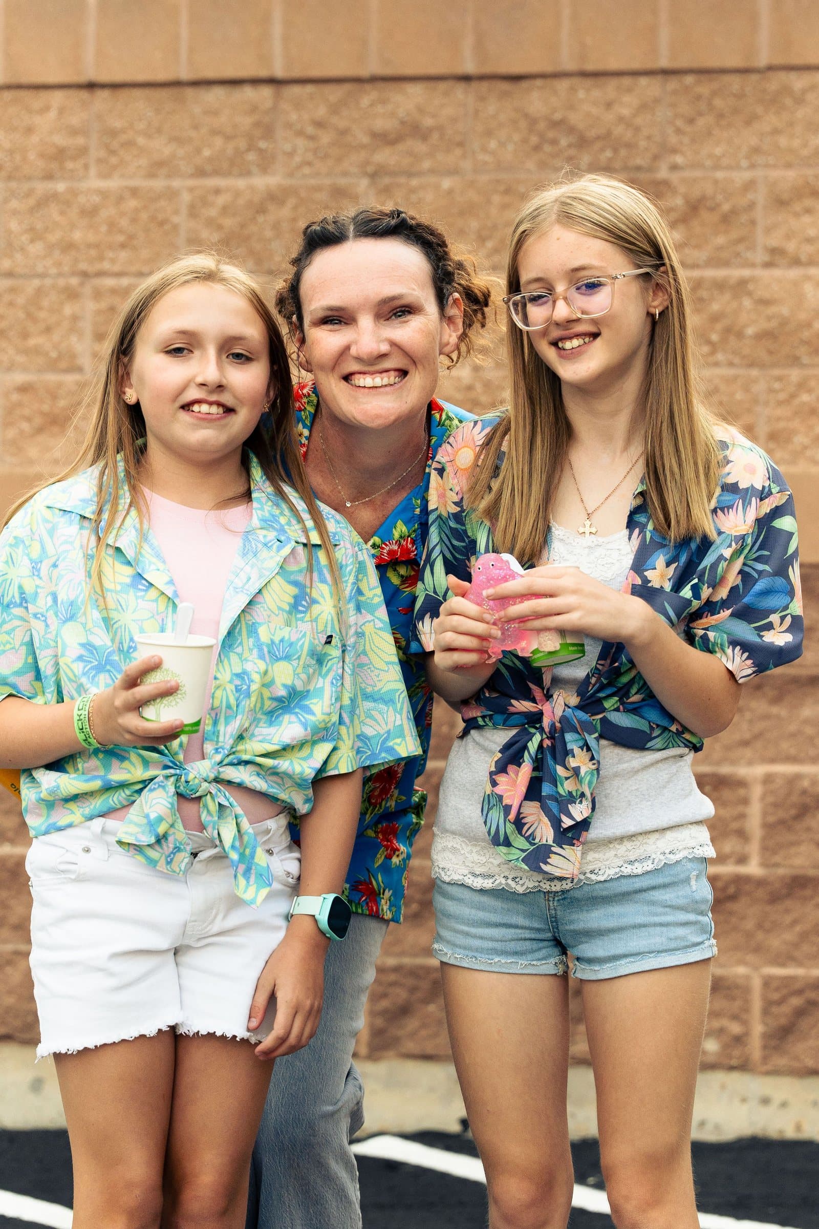 Three friends in Hawaiian shirts laughing at a church youth night