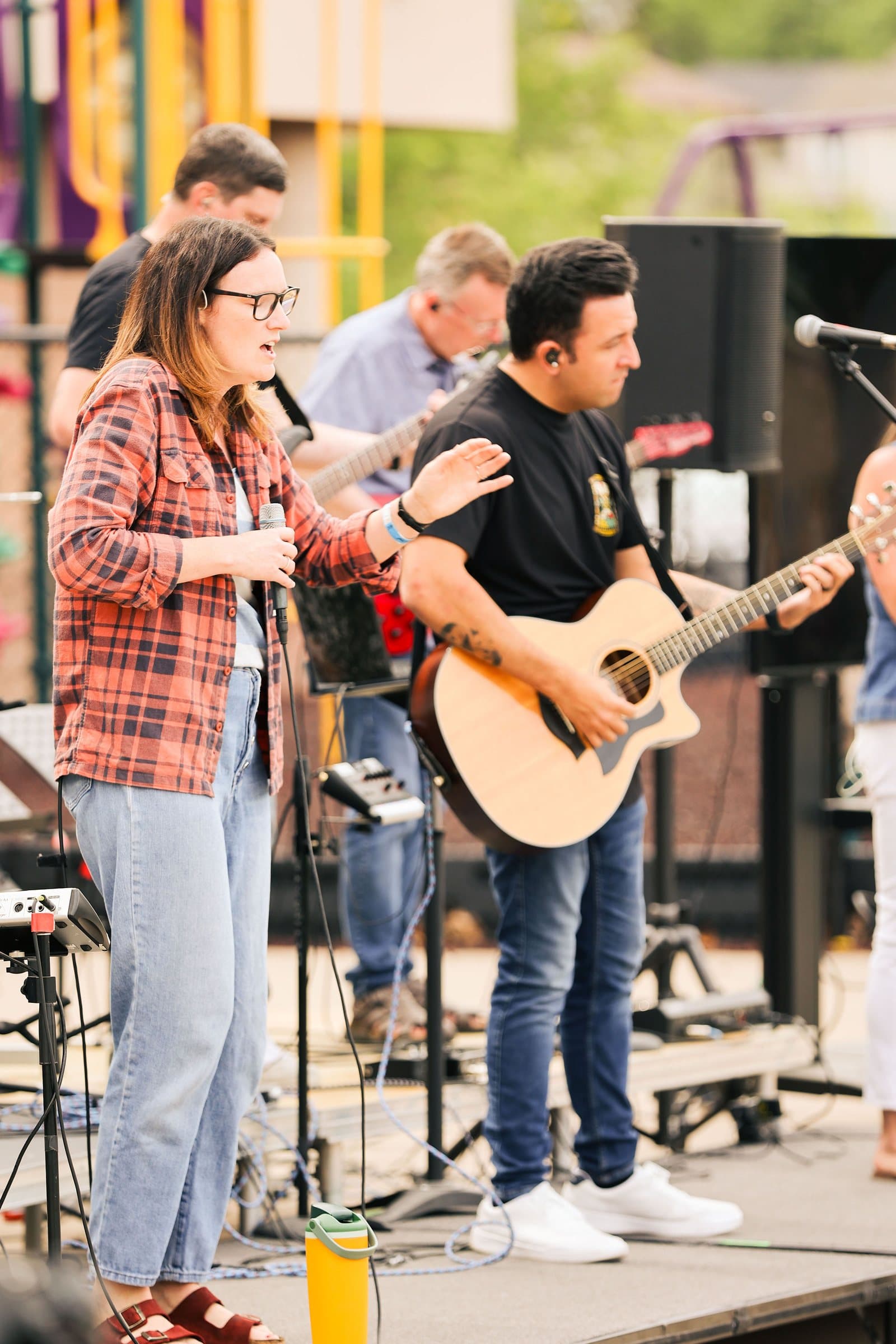 Worship band performing on stage at an outdoor church service, Colorado event photography