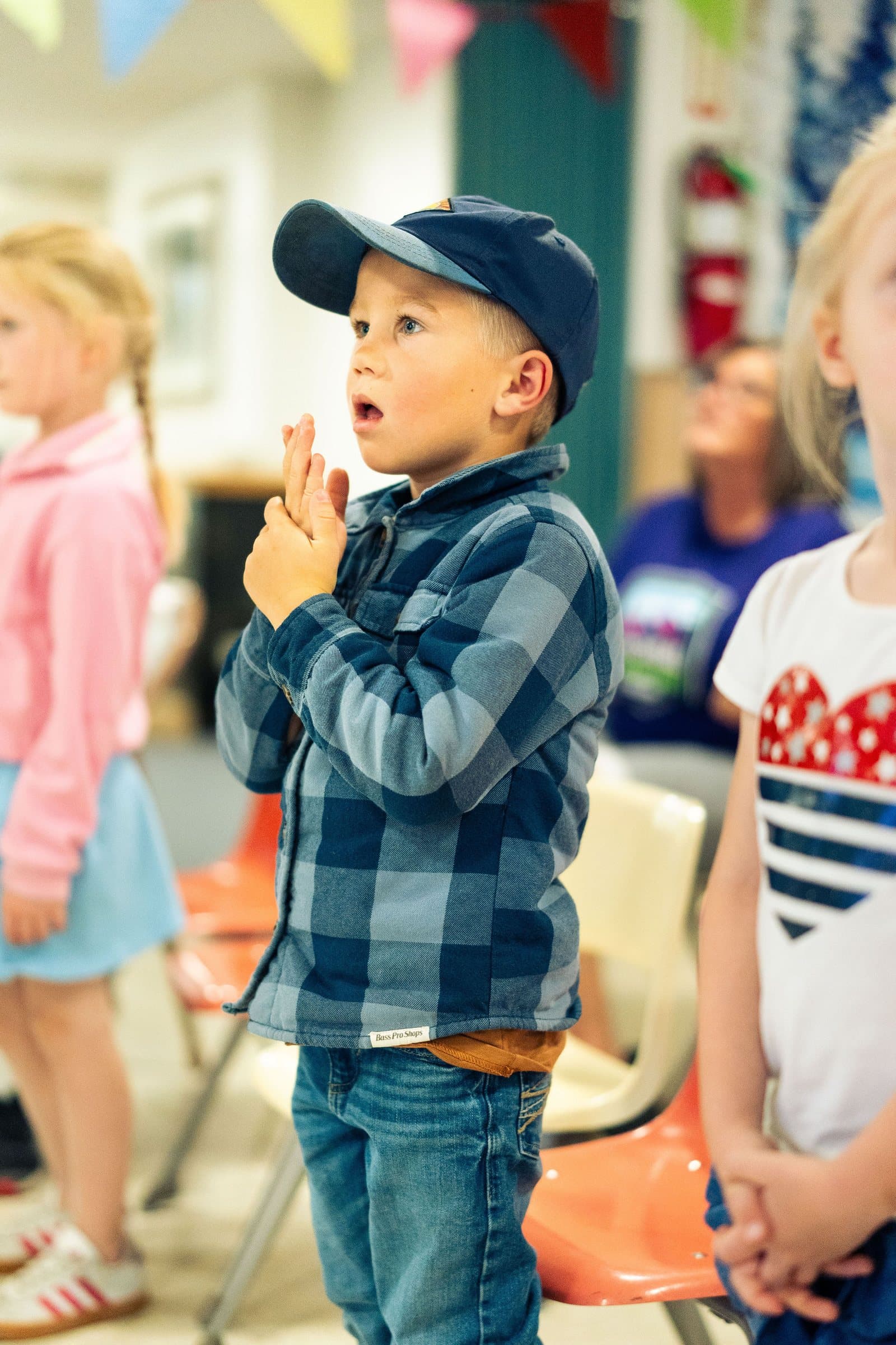 Children singing along during worship time at Vacation Bible School 2026
