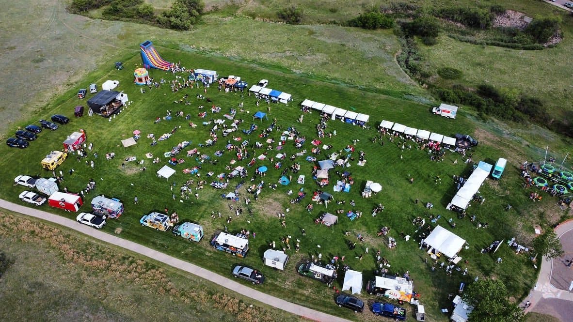 Drone aerial of Castle Pines Food Truck Frenzy 2026 with food trucks lining the park
