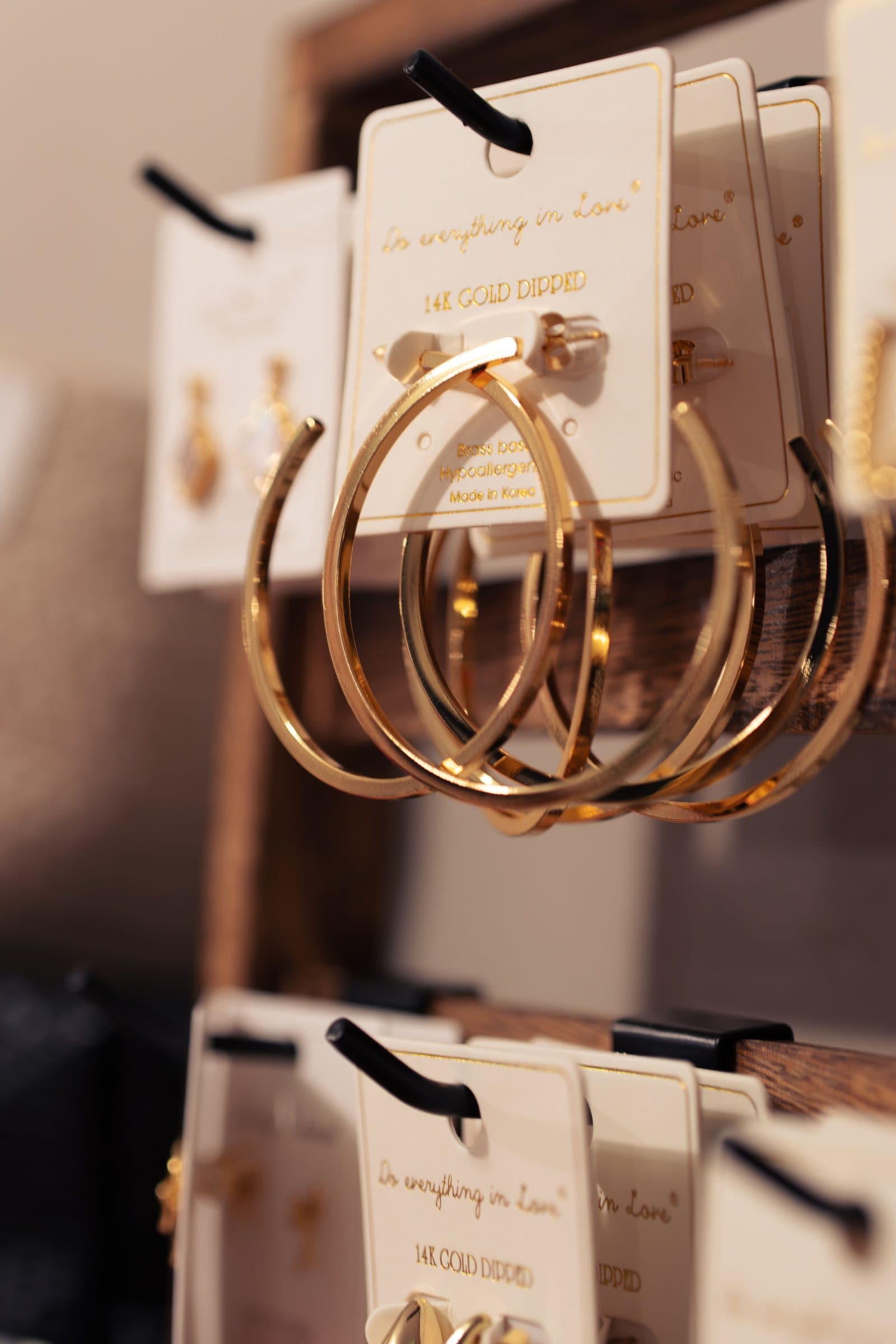 Gold hoop earrings displayed on a card at Corner Nook boutique, product photography