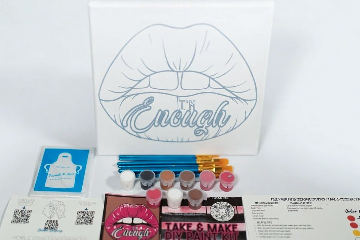 DIY paint kit with 'I'm Enough' canvas, brushes and paints on white, product photography