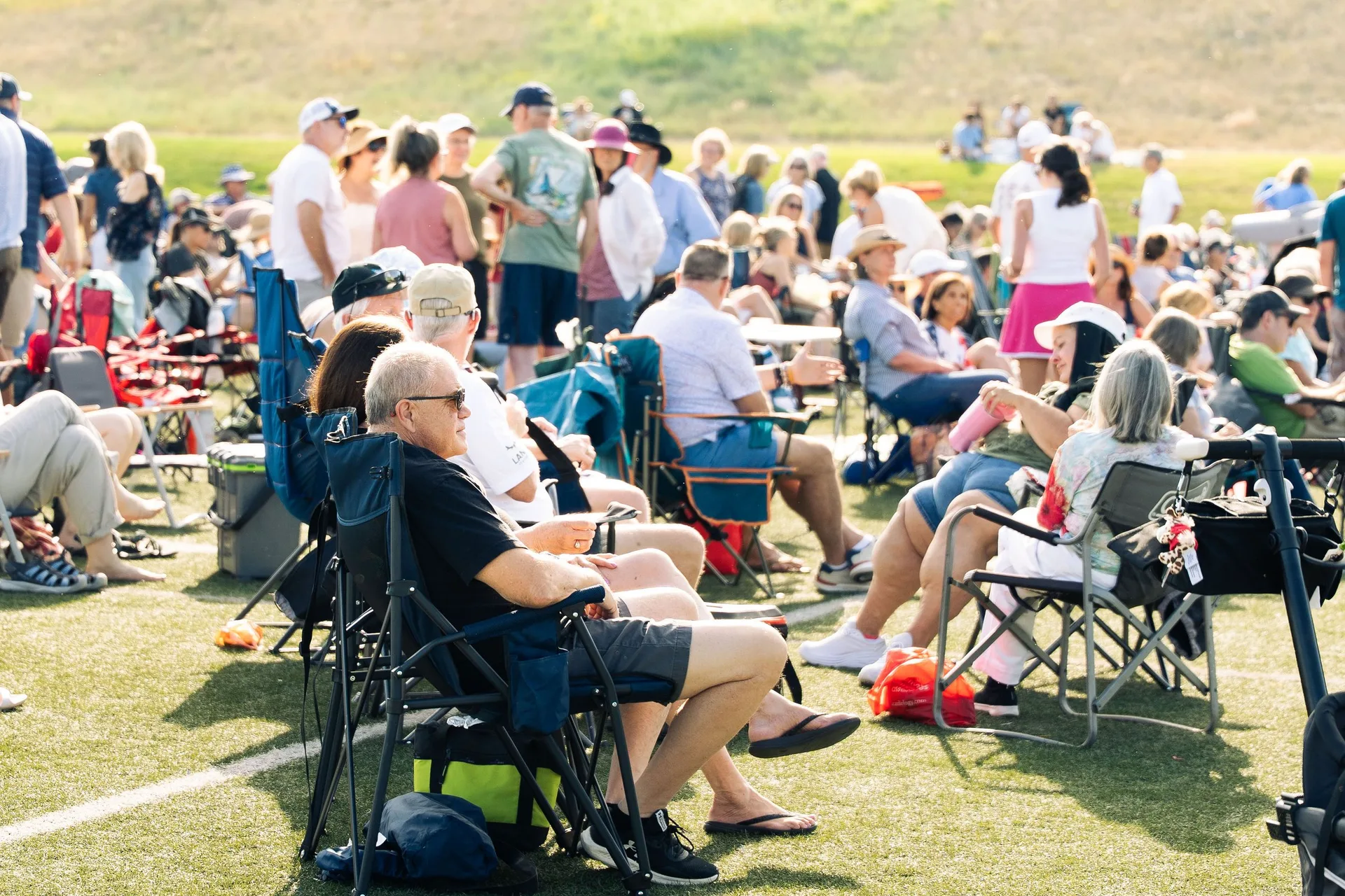 Crowd relaxing on the lawn at the Castle Pines summer concert, Colorado event photography
