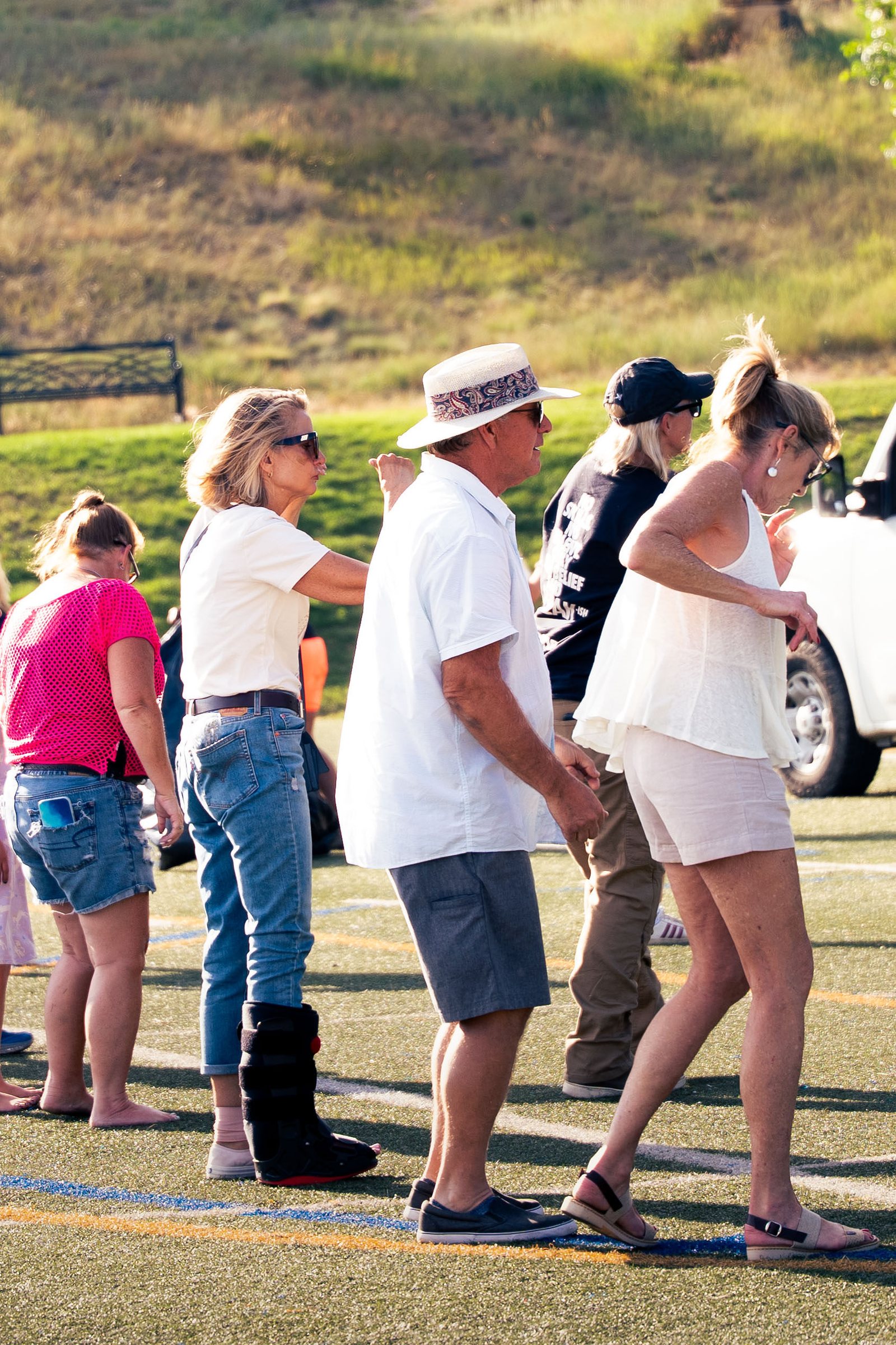 Group of women line dancing at the Castle Pines outdoor concert