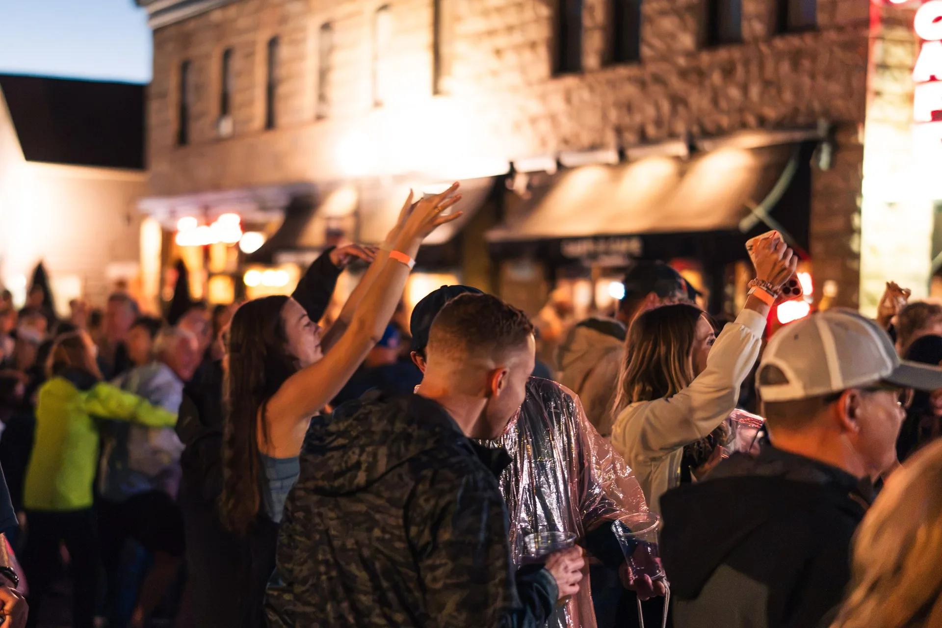 Festival crowd dancing at night on the streets of Castle Rock during Oktoberfest 2026