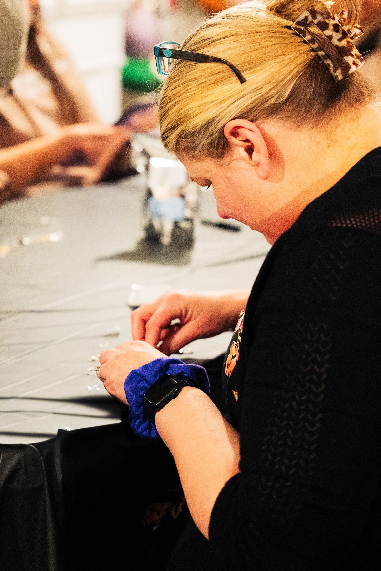 Maker working on a craft at the Corner Nook workshop table