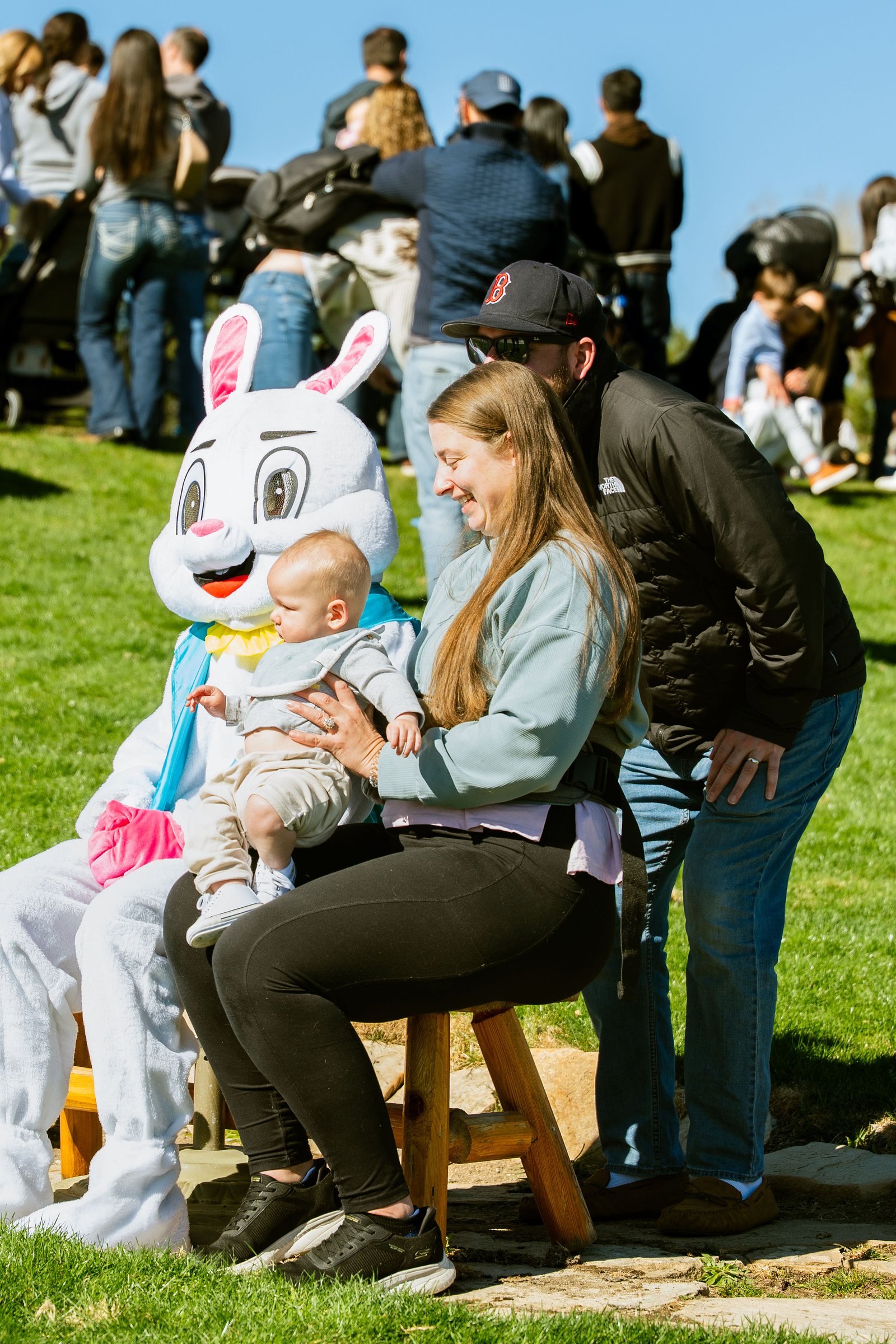 Family posing with the Easter Bunny at the Easter egg hunt
