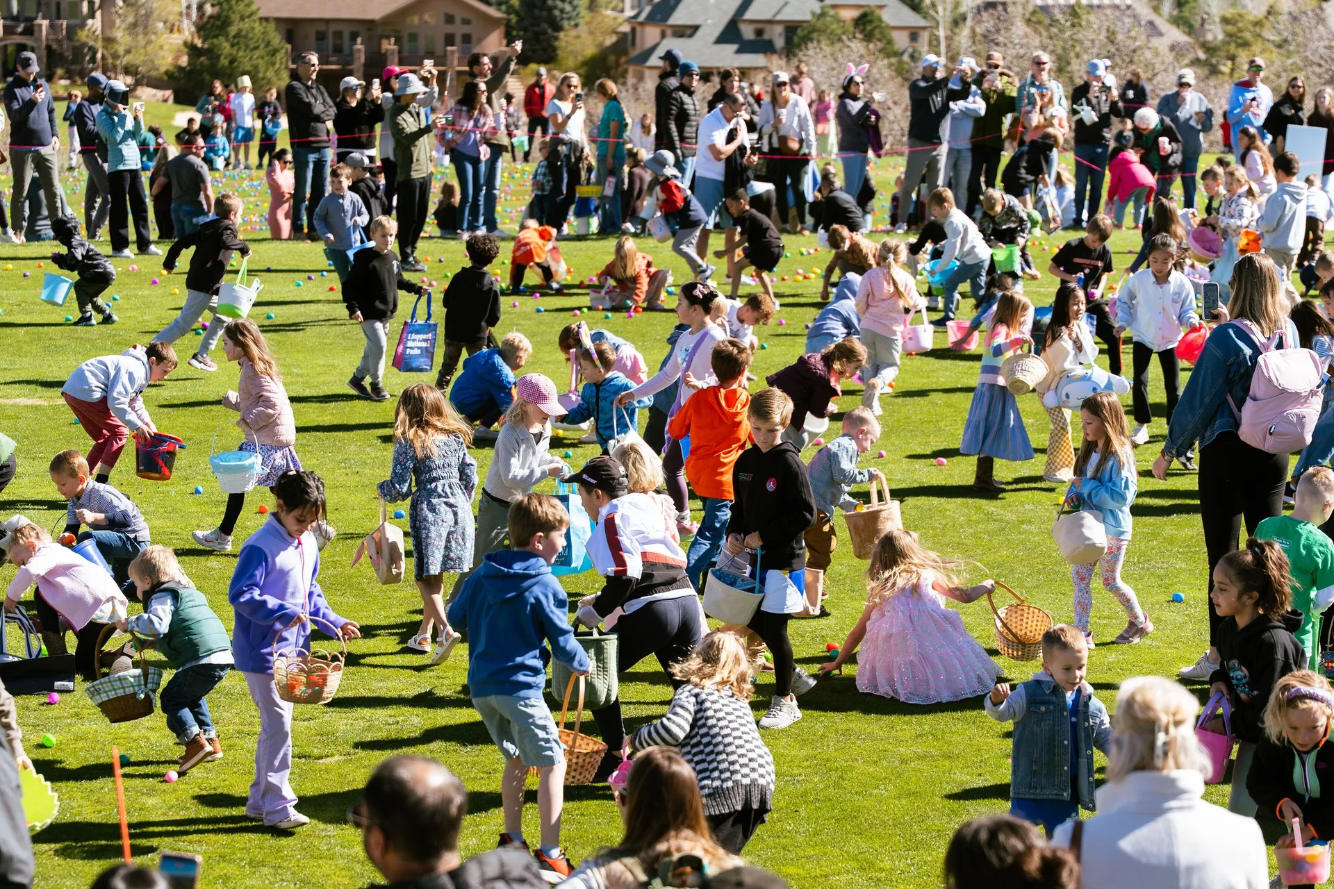 Children racing across the field at the start of the Easter egg hunt