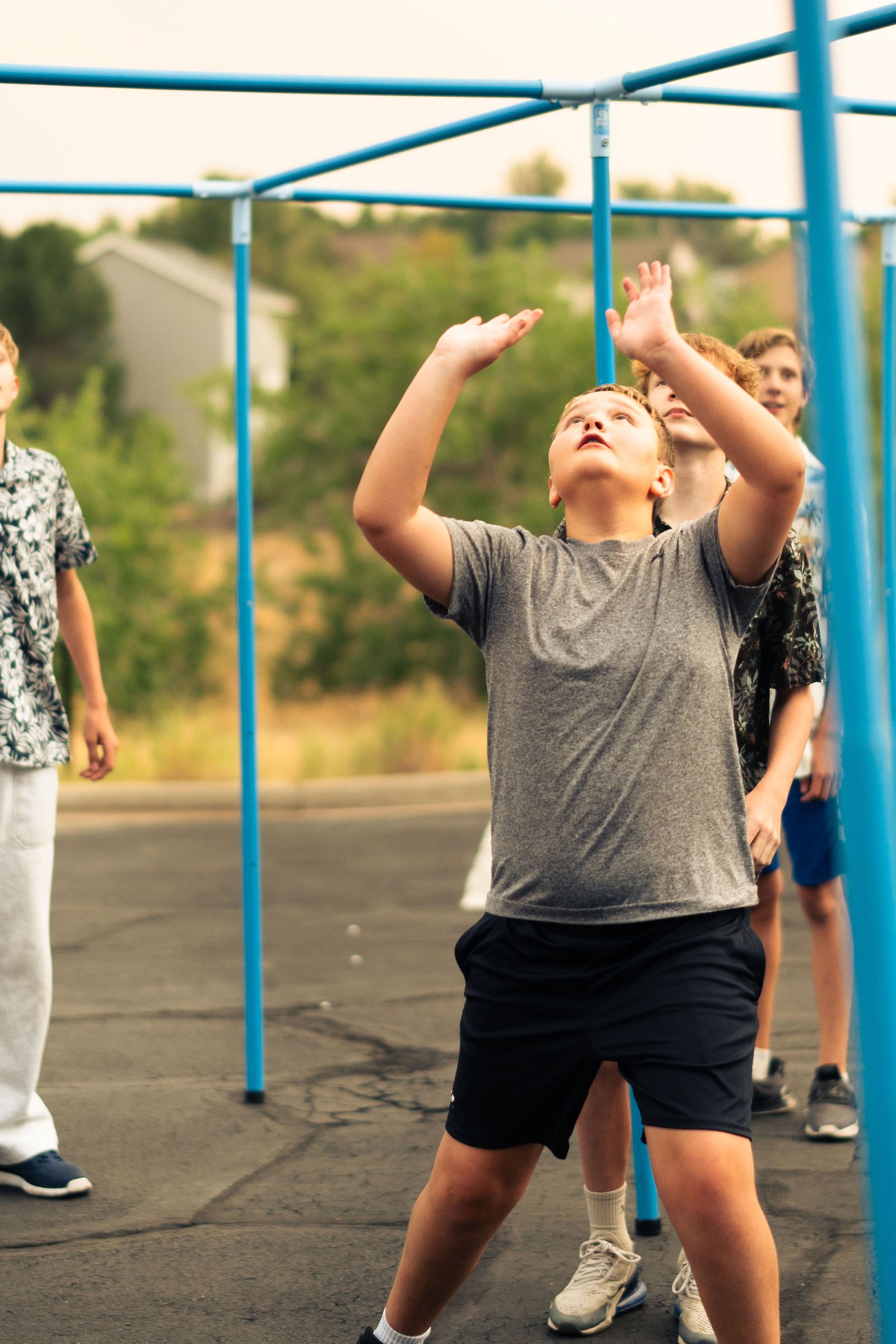 Teen tossing a giant ball during an outdoor youth group game