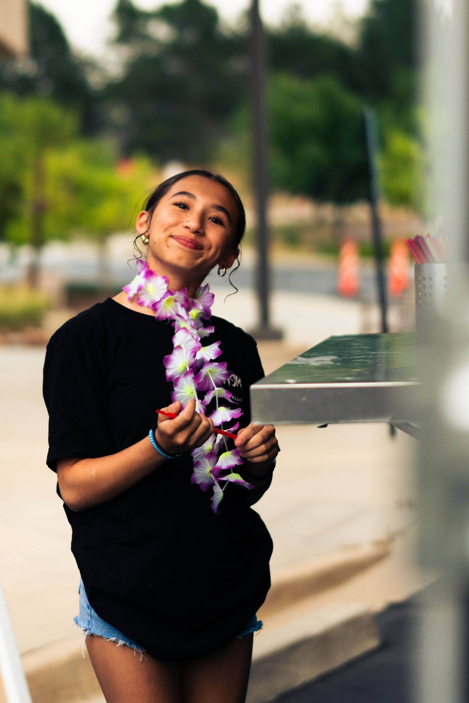 Smiling teen wearing a lei at a church youth night in Colorado