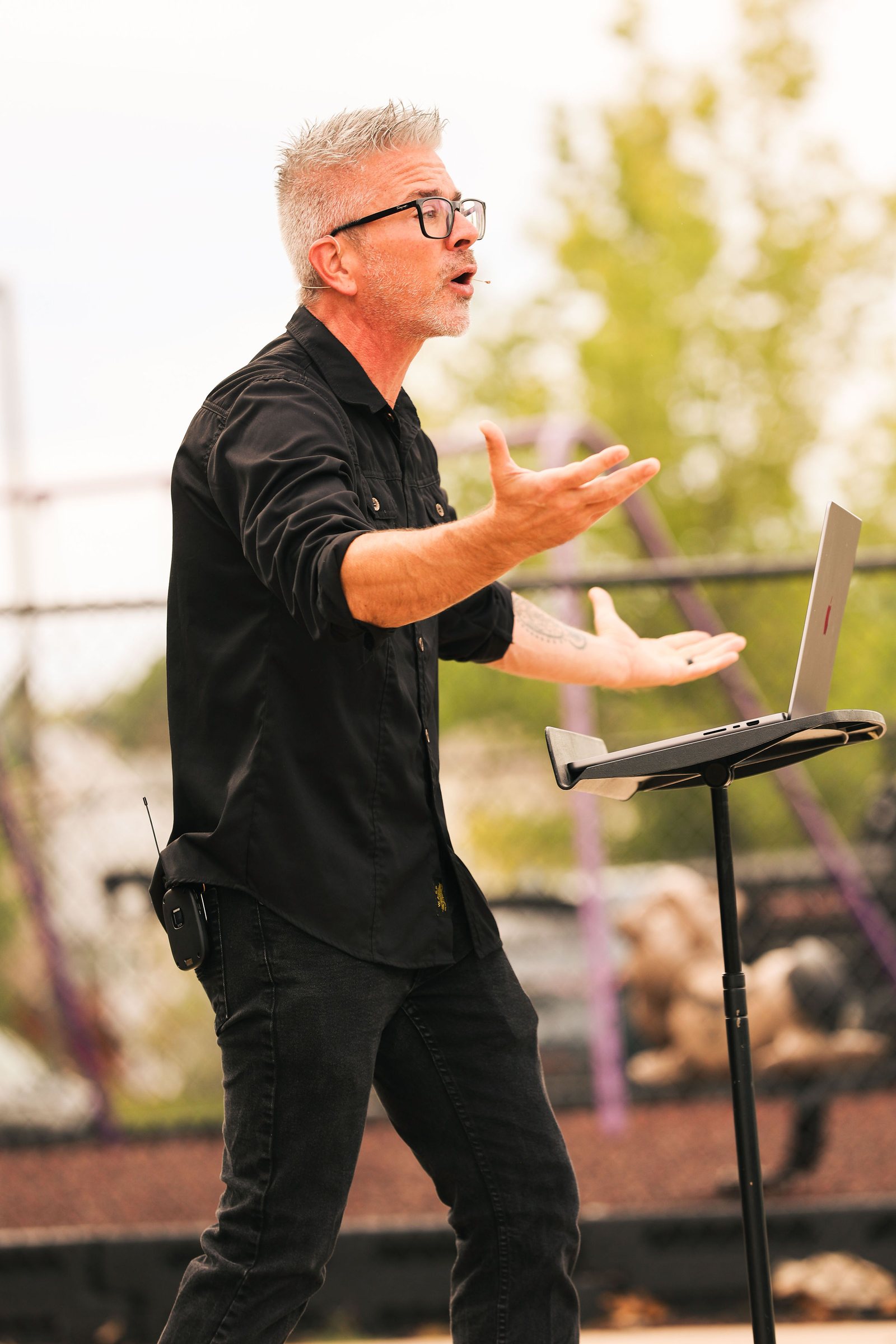 Pastor preaching at an outdoor church gathering in Colorado