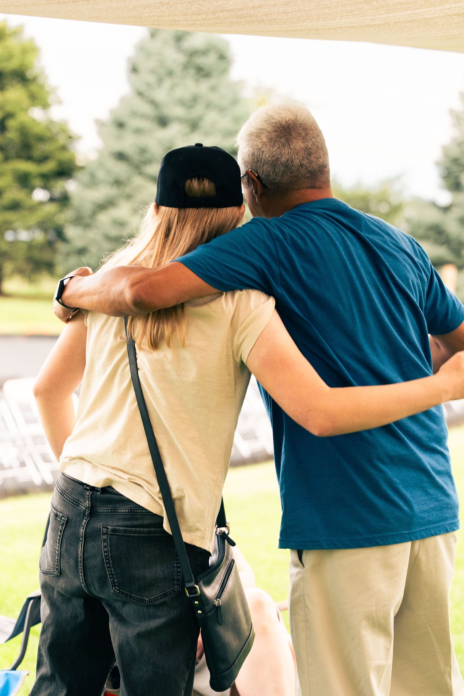 Two friends embracing at the Mountain View church outdoor gathering