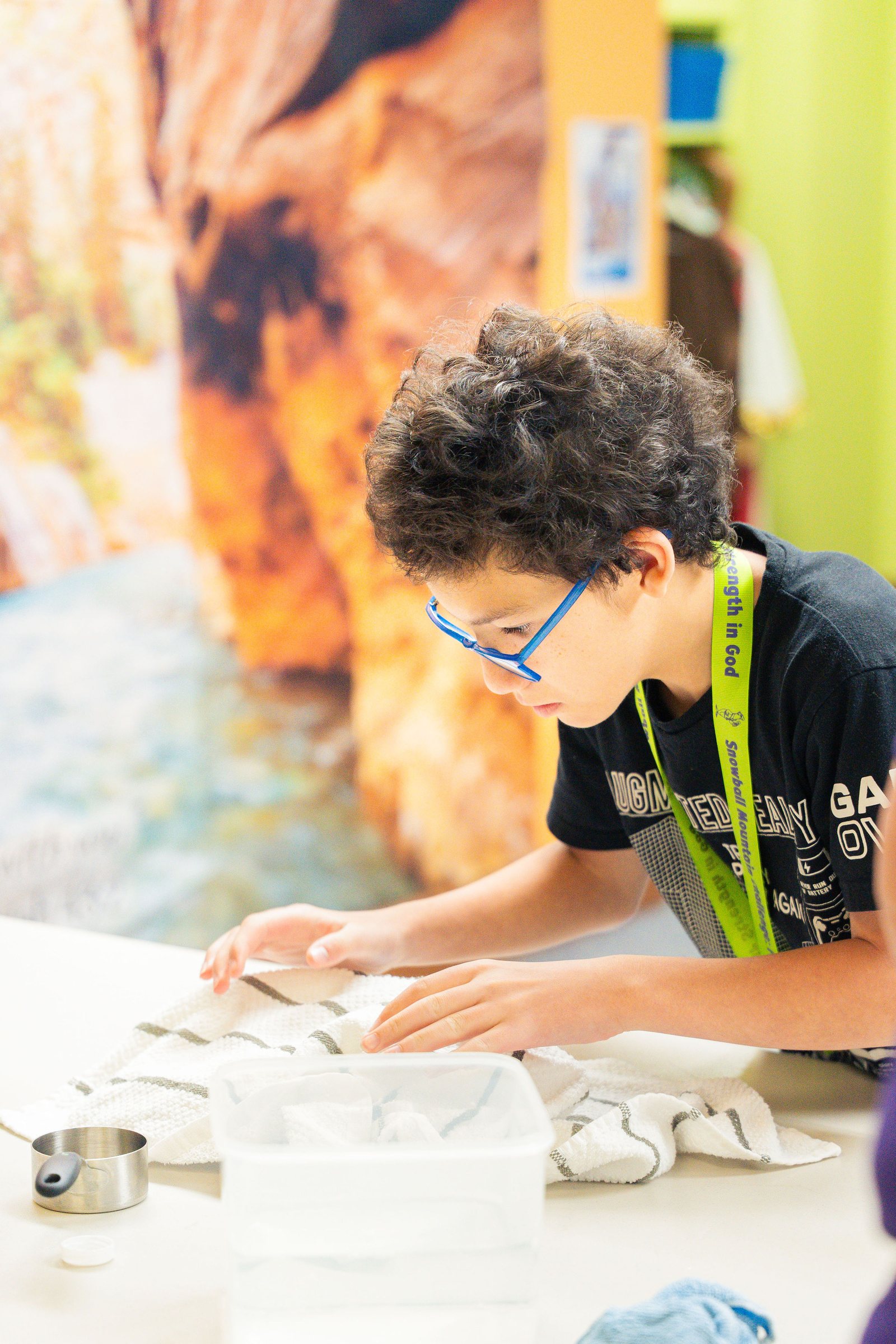 Child concentrating on a craft project at Vacation Bible School