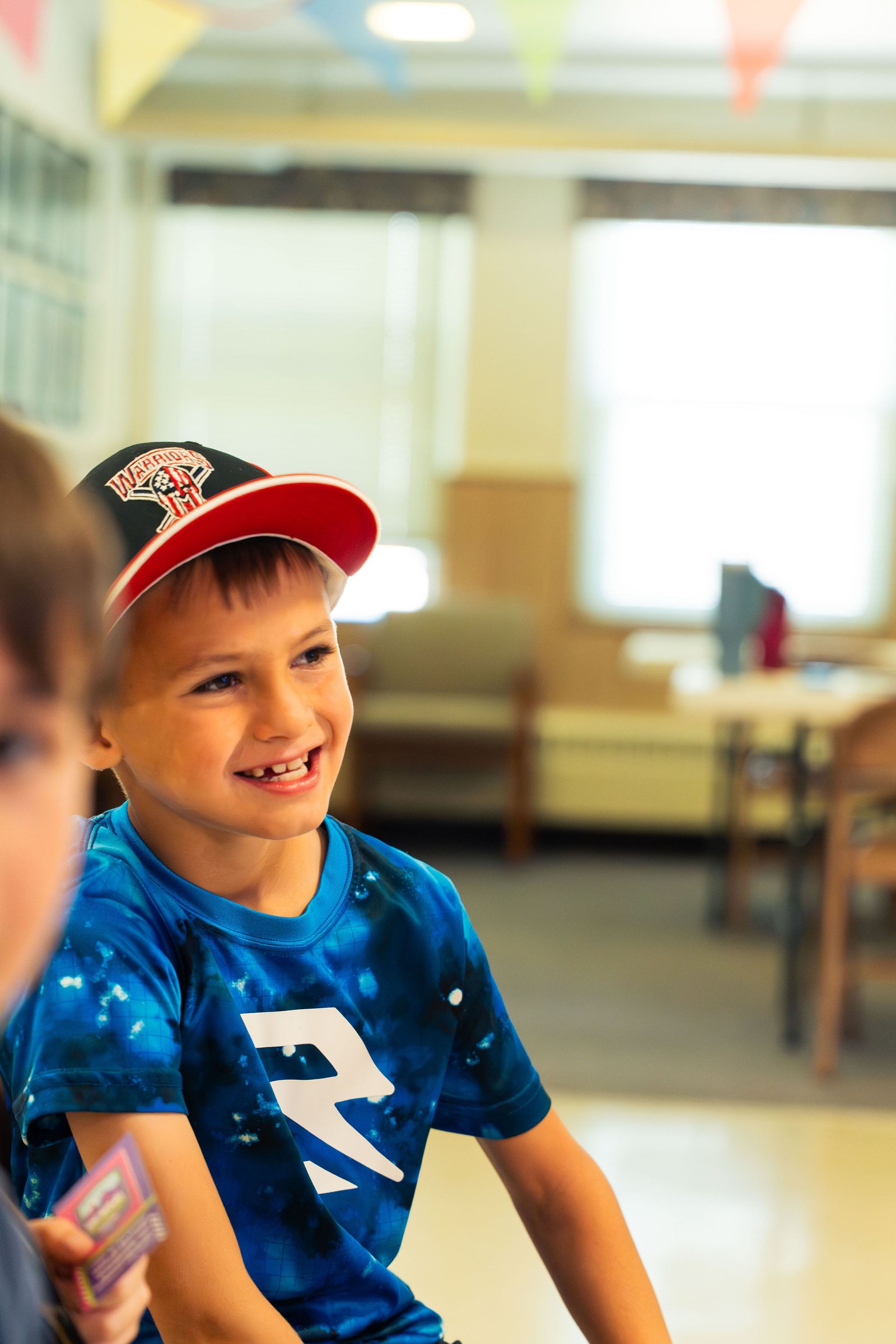 Smiling boy in a Seahawks jersey at Vacation Bible School 2026